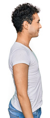 Young handsome man wearing casual white t shirt looking to side, relax profile pose with natural face with confident smile.