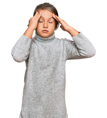 Little beautiful girl wearing casual turtleneck sweater suffering from headache desperate and stressed because pain and migraine. hands on head.