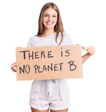 Young beautiful blonde woman holding there is no planet b banner smiling happy pointing with hand and finger