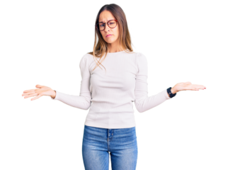 Beautiful brunette young woman wearing casual white sweater and glasses clueless and confused with open arms, no idea concept.