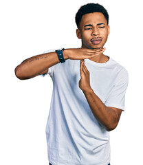Young african american man wearing casual white t shirt doing time out gesture with hands,...