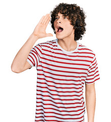 Caucasian teenager wearing casual clothes shouting and screaming loud to side with hand on mouth....