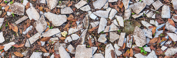 Panoramic image. Shards of smashed roof tiles covering the floor
