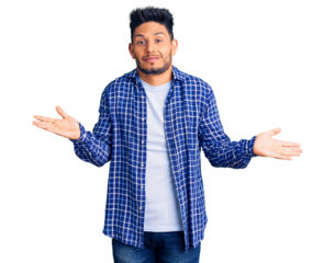 Handsome latin american young man wearing casual shirt clueless and confused expression with arms and hands raised. doubt concept.