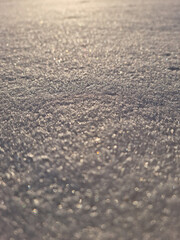 Texture of fresh snow covering the ground in winter .