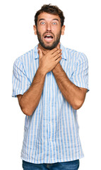 Handsome young man with beard wearing casual fresh shirt shouting and suffocate because painful strangle. health problem. asphyxiate and suicide concept.