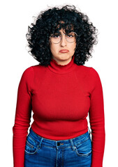 Young middle east girl wearing casual clothes and glasses looking sleepy and tired, exhausted for fatigue and hangover, lazy eyes in the morning.