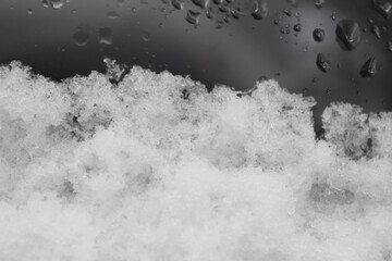 A car with snow covering most of the windows after a snowstorm. 