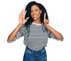 Middle age african american woman wearing casual clothes showing and pointing up with fingers number six while smiling confident and happy.