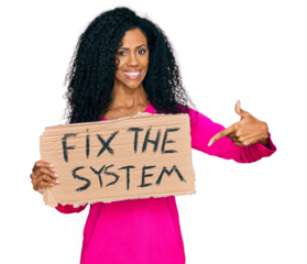 Middle age african american woman holding fix the system banner cardboard smiling happy pointing with hand and finger