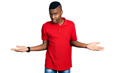 Young african american man wearing casual red t shirt clueless and confused with open arms, no idea concept.