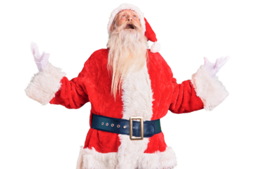 Old senior man with grey hair and long beard wearing traditional santa claus costume crazy and mad shouting and yelling with aggressive expression and arms raised. frustration concept.