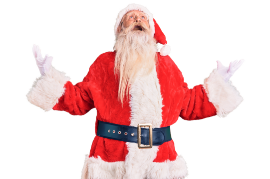Old senior man with grey hair and long beard wearing traditional santa claus costume crazy and mad shouting and yelling with aggressive expression and arms raised. frustration concept.