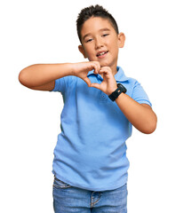 Little boy hispanic kid wearing casual clothes smiling in love doing heart symbol shape with hands. romantic concept.