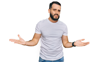 Young man with beard wearing casual white t shirt clueless and confused with open arms, no idea concept.