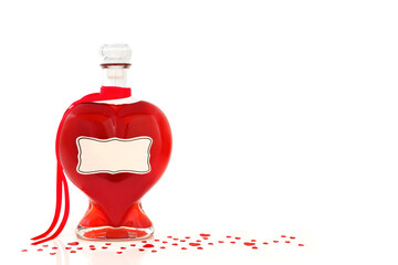 Heart shaped perfume bottle and loose red heart confetti on white background. Gift for Valentines,...