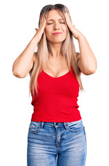Young beautiful blonde woman wearing casual clothes suffering from headache desperate and stressed because pain and migraine. hands on head.