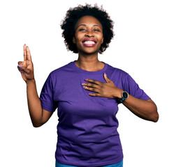 African american woman with afro hair wearing casual purple t shirt smiling swearing with hand on...