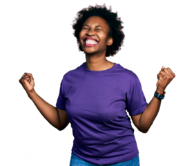 African american woman with afro hair wearing casual purple t shirt very happy and excited doing winner gesture with arms raised, smiling and screaming for success. celebration concept.