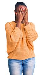 Young african american woman wearing casual clothes with sad expression covering face with hands...