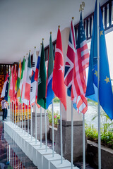 National flags of different countries indoors during government meeting, conference summit, forum or other international event