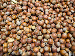a lot of nuts: almonds, peanuts, pistachios are in a box in the store.
