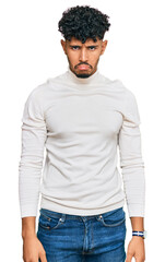 Young arab man wearing casual winter sweater depressed and worry for distress, crying angry and afraid. sad expression.