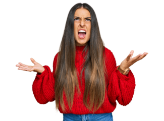 Beautiful hispanic woman wearing casual clothes crazy and mad shouting and yelling with aggressive expression and arms raised. frustration concept.
