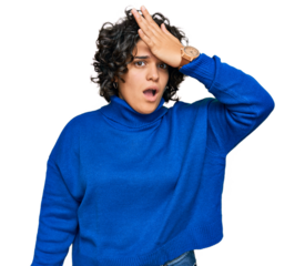 Young hispanic woman with curly hair wearing turtleneck sweater surprised with hand on head for mistake, remember error. forgot, bad memory concept.
