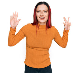 Young caucasian woman wearing casual clothes showing and pointing up with fingers number nine while...