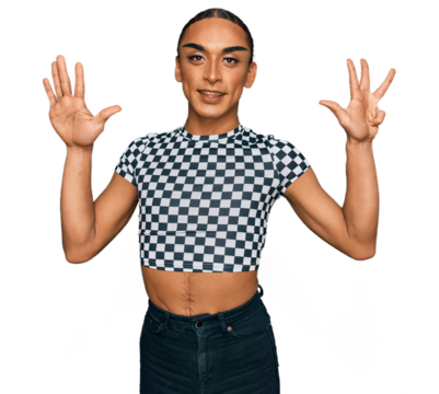 Hispanic transgender man wearing make up and long hair wearing modern clothes showing and pointing up with fingers number nine while smiling confident and happy.