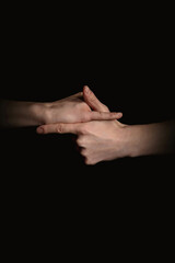 human hands with anime gestures on a black background