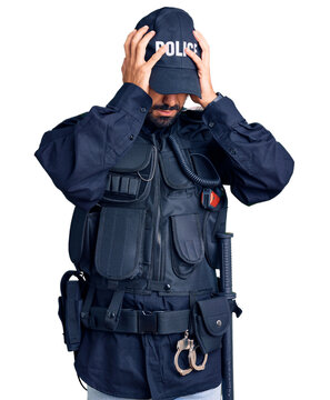 Young hispanic man wearing police uniform suffering from headache desperate and stressed because pain and migraine. hands on head.