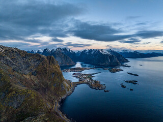 aerial view from the sea over reine fisherman  village on lofoten islands in norway during sunrise...