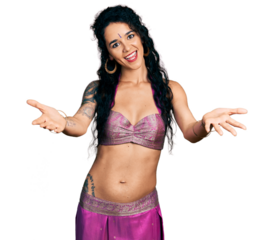 Young indian woman wearing belly dancer costume smiling cheerful offering hands giving assistance and acceptance.