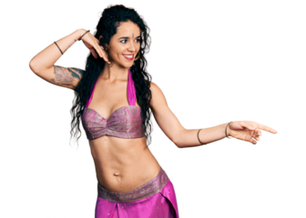 Young indian woman wearing belly dancer costume dancing happy and cheerful, smiling moving casual and confident listening to music
