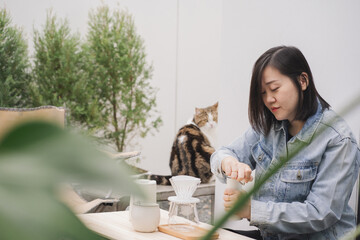 people activity concept with asian woman happy feeling for drip and drink coffee at home with her cat