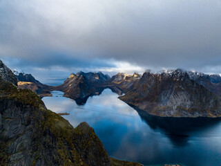 aerial view over mountains with reflections in water on lofoten islands in norway
