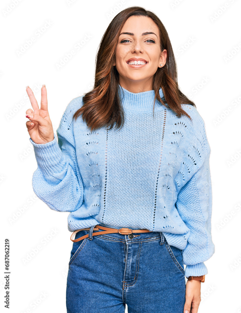 Poster young brunette woman wearing casual winter sweater smiling looking to the camera showing fingers doi