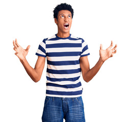 Young african american man wearing casual clothes crazy and mad shouting and yelling with...