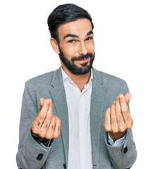 Young hispanic man wearing business clothes doing money gesture with hands, asking for salary...