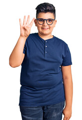Little boy kid wearing casual clothes and glasses showing and pointing up with fingers number four while smiling confident and happy.