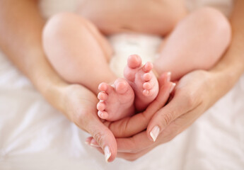Woman, child and feet holding for love connection or childhood bonding, motherhood or newborn....