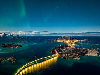 aerial view over Hillesøya and Sommarøy islands during night with northern lights in the sky