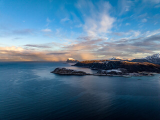 aerial view over norwegian mountains covered with snow not far from tromso