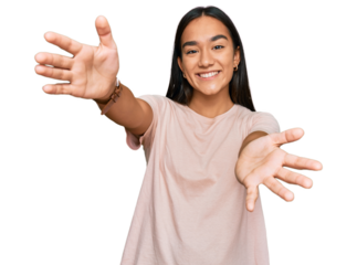 Young asian woman wearing casual clothes looking at the camera smiling with open arms for hug. cheerful expression embracing happiness.