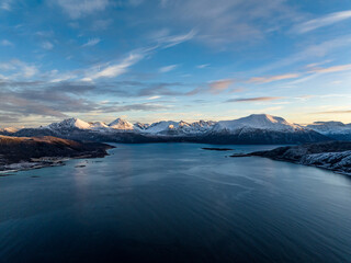 aerial view over norwegian mountains covered with snow not far from tromso