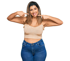 Fototapeta premium Beautiful brunette woman wearing casual clothes smiling cheerful showing and pointing with fingers teeth and mouth. dental health concept.