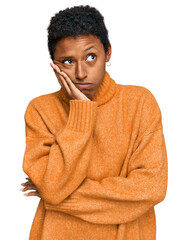 Young african american woman wearing casual clothes thinking looking tired and bored with...