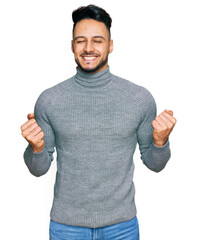 Young arab man wearing casual clothes excited for success with arms raised and eyes closed celebrating victory smiling. winner concept.